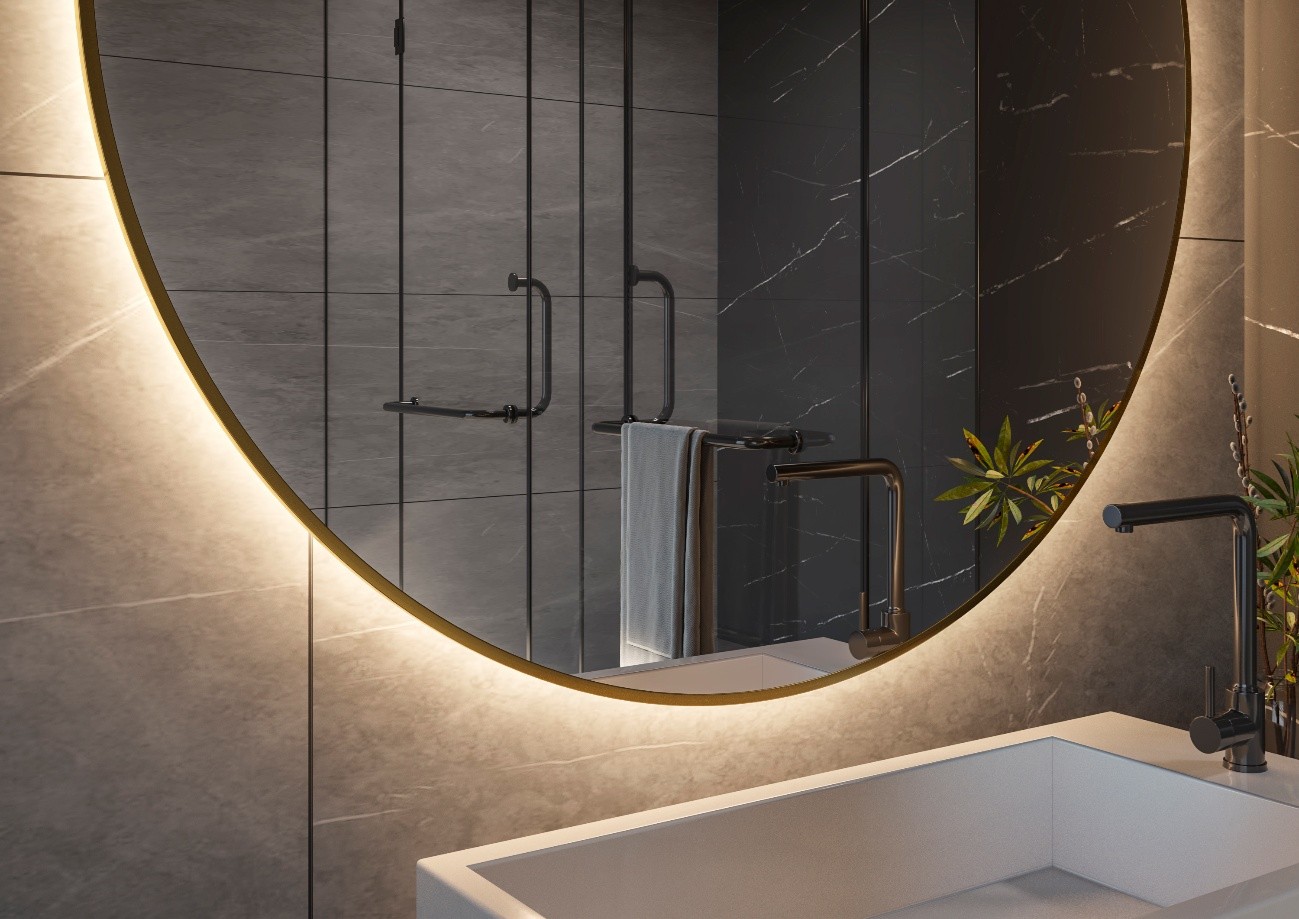 Espejo redondo retroiluminado en baño moderno con iluminación ambiental cálida.