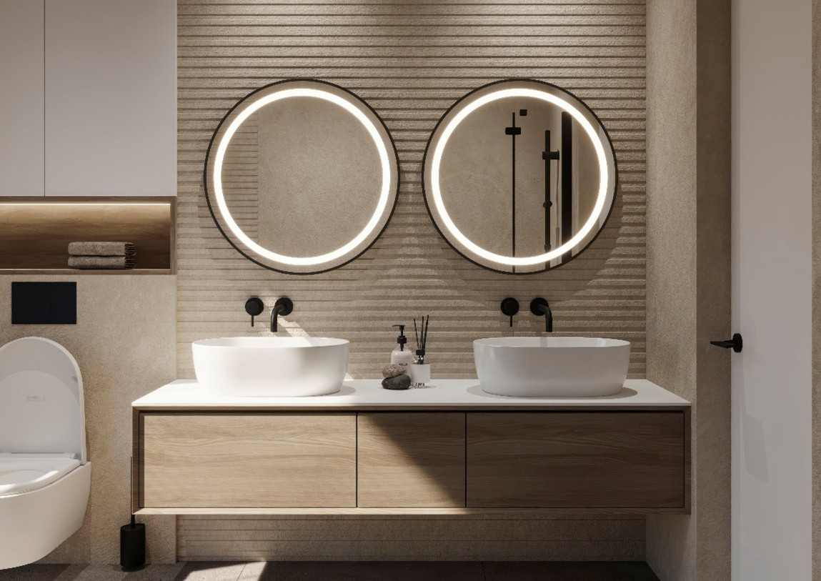 Dos espejos redondos con iluminación LED integrada en baño moderno con doble lavabo.